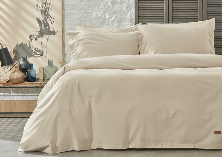Plain duvet cover set in beige color displayed in bedroom